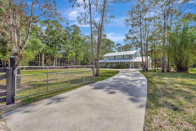 16095 121st Ter N, Jupiter, FL 33478 - view of front of home featuring a gate, driveway, and metal roof