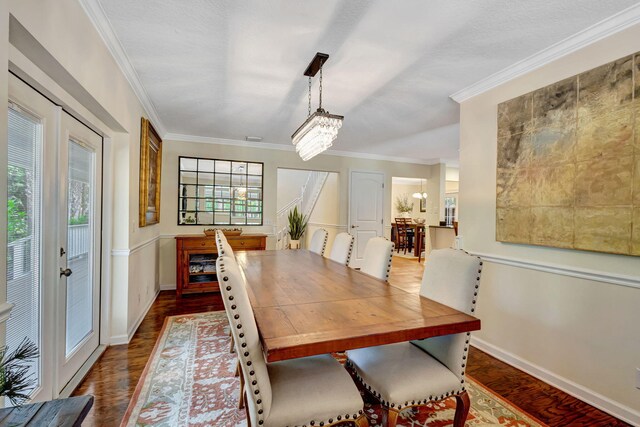 16095 121st Ter N, Jupiter, FL 33478 - dining area with a chandelier, dark wood finished floors, ornamental molding, and baseboards