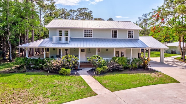 16095 121st Ter N, Jupiter, FL 33478 - farmhouse inspired home featuring metal roof, a front yard, french doors, and concrete driveway