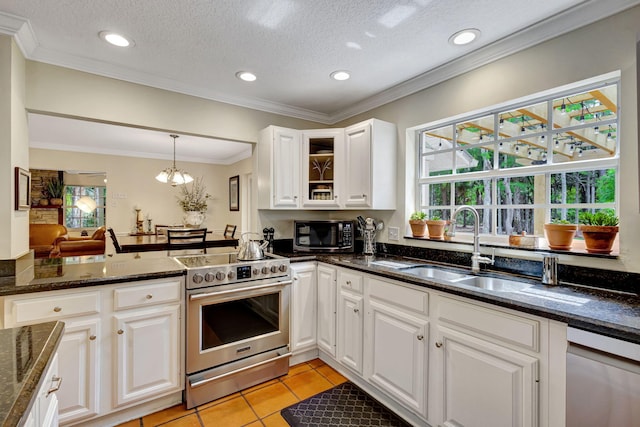 16095 121st Ter N, Jupiter, FL 33478 - kitchen with appliances with stainless steel finishes, plenty of natural light, white cabinetry, glass insert cabinets, and recessed lighting