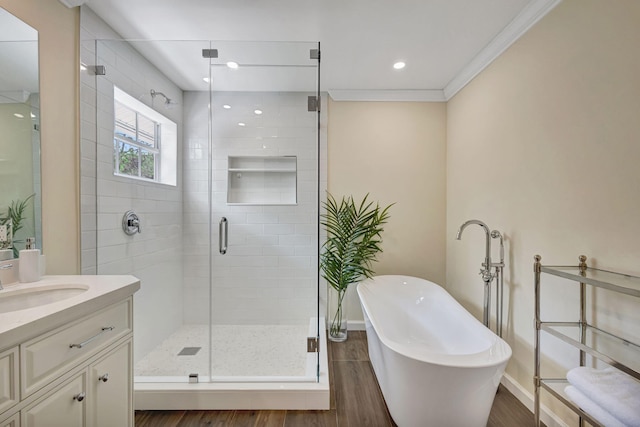 16095 121st Ter N, Jupiter, FL 33478 - bathroom with vanity, a freestanding tub, a stall shower, wood finished floors, and crown molding