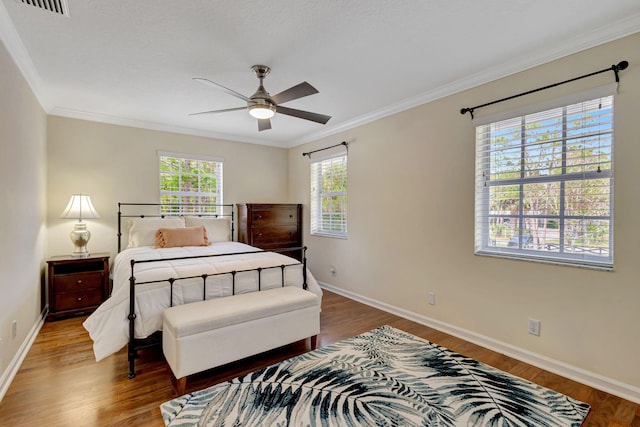 16095 121st Ter N, Jupiter, FL 33478 - bedroom featuring crown molding, wood finished floors, baseboards, and ceiling fan