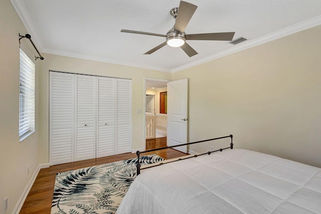 16095 121st Ter N, Jupiter, FL 33478 - bedroom with ornamental molding, wood finished floors, a closet, baseboards, and ceiling fan