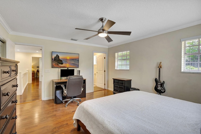 16095 121st Ter N, Jupiter, FL 33478 - bedroom featuring wood finished floors, a textured ceiling, an office area, ornamental molding, and a ceiling fan