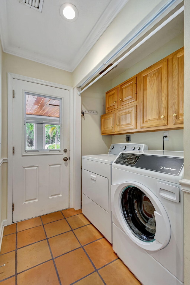 16095 121st Ter N, Jupiter, FL 33478 - laundry room with washer and dryer, cabinet space, light tile patterned floors, and crown molding