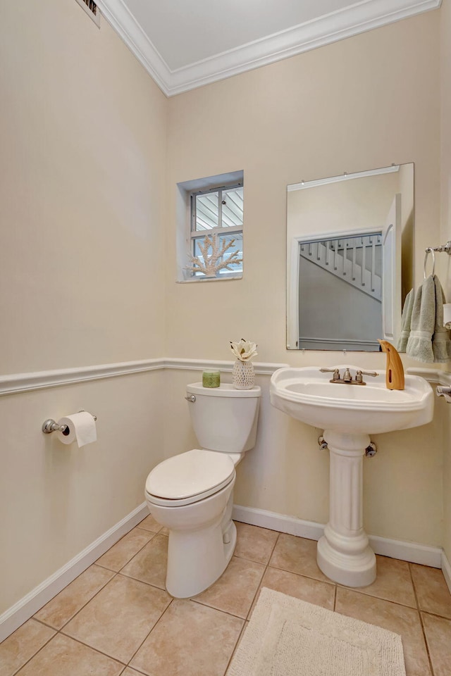 16095 121st Ter N, Jupiter, FL 33478 - bathroom featuring toilet, ornamental molding, tile patterned floors, and baseboards