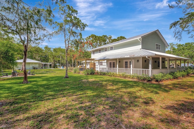 16095 121st Ter N, Jupiter, FL 33478 - view of front of house featuring a fire pit, a front lawn, and metal roof