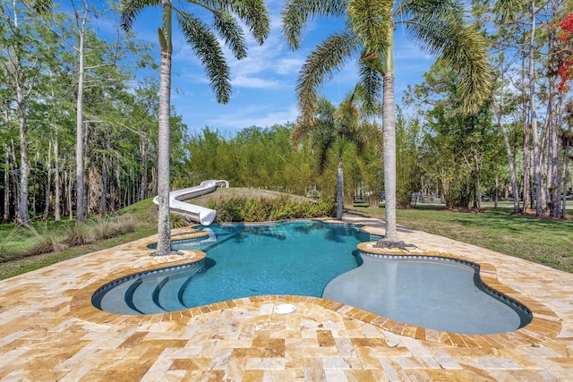 16095 121st Ter N, Jupiter, FL 33478 - outdoor pool featuring a water slide, a patio area, and a yard