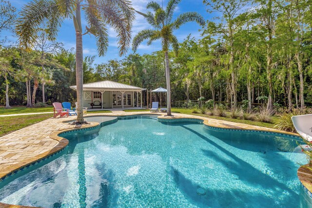 16095 121st Ter N, Jupiter, FL 33478 - outdoor pool with a patio, an exterior structure, and an outdoor structure