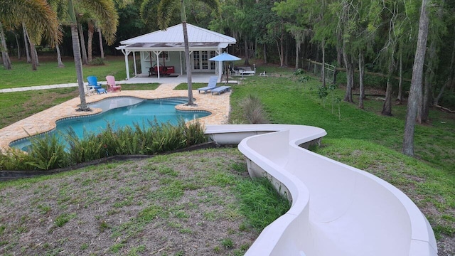 16095 121st Ter N, Jupiter, FL 33478 - outdoor pool with a patio area and a lawn