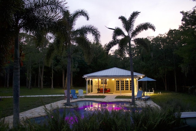 16095 121st Ter N, Jupiter, FL 33478 - swimming pool with a patio, a storage structure, french doors, an outbuilding, and a view of trees