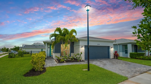 12734 SW Phoenix Dr, Port Saint Lucie, FL 34987 - single story home with a garage, stucco siding, decorative driveway, and stone siding
