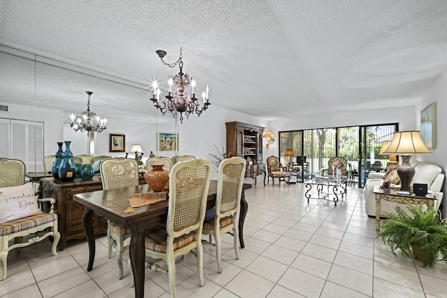 5153 Oak Hill Ln Unit 512, Delray Beach, FL 33484 - dining space featuring a chandelier, light tile patterned flooring, and a textured ceiling
