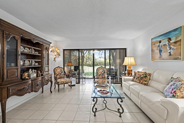 5153 Oak Hill Ln Unit 512, Delray Beach, FL 33484 - living area featuring a textured ceiling and light tile patterned floors