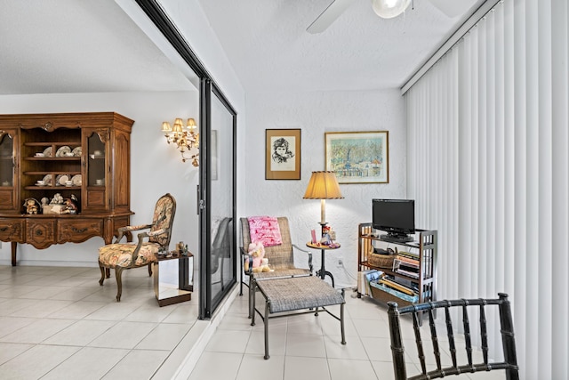 5153 Oak Hill Ln Unit 512, Delray Beach, FL 33484 - sitting room with a ceiling fan, a textured ceiling, and light tile patterned flooring