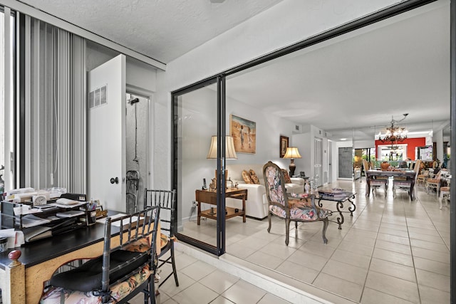 5153 Oak Hill Ln Unit 512, Delray Beach, FL 33484 - dining space with light tile patterned floors, a chandelier, and a textured ceiling