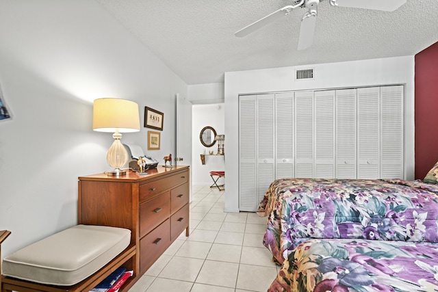 5153 Oak Hill Ln Unit 512, Delray Beach, FL 33484 - bedroom featuring light tile patterned flooring, a closet, a textured ceiling, and a ceiling fan