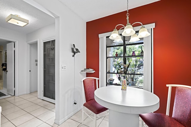 5153 Oak Hill Ln Unit 512, Delray Beach, FL 33484 - dining room featuring a chandelier, light tile patterned floors, and a textured ceiling