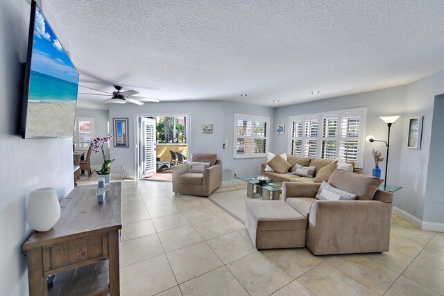 20 Uno Lago Dr, Juno Beach, FL 33408 - living area with light tile patterned floors, ceiling fan, a textured ceiling, and baseboards