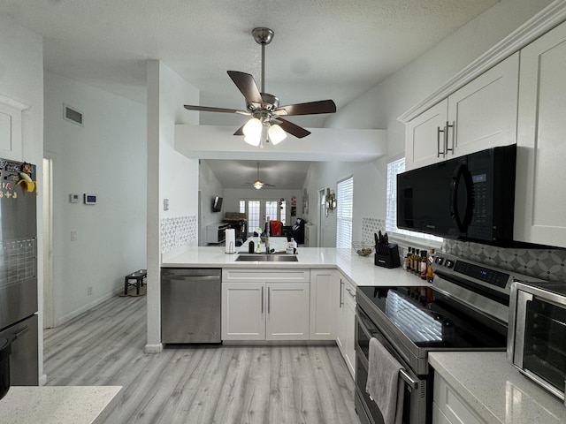 1518 Royal Forest Ct, Palm Springs, FL 33406 - kitchen with stainless steel appliances, tasteful backsplash, light wood-style floors, ceiling fan, and lofted ceiling
