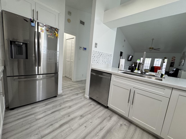 1518 Royal Forest Ct, Palm Springs, FL 33406 - kitchen featuring appliances with stainless steel finishes, light wood-type flooring, a ceiling fan, light countertops, and white cabinetry
