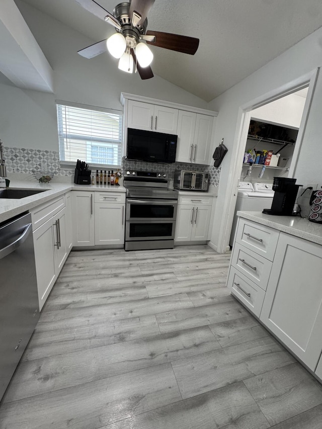 1518 Royal Forest Ct, Palm Springs, FL 33406 - kitchen featuring stainless steel appliances, washing machine and clothes dryer, a sink, ceiling fan, and decorative backsplash