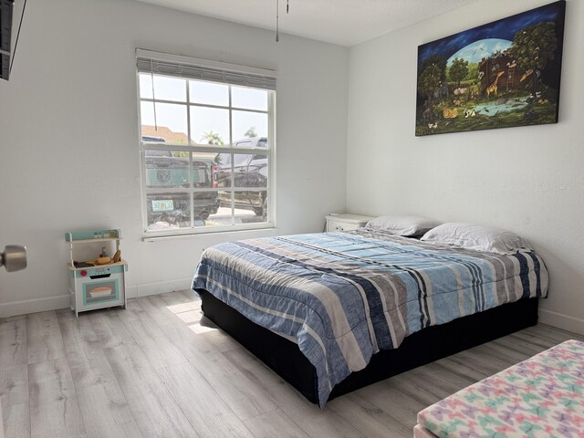1518 Royal Forest Ct, Palm Springs, FL 33406 - bedroom featuring wood finished floors and baseboards