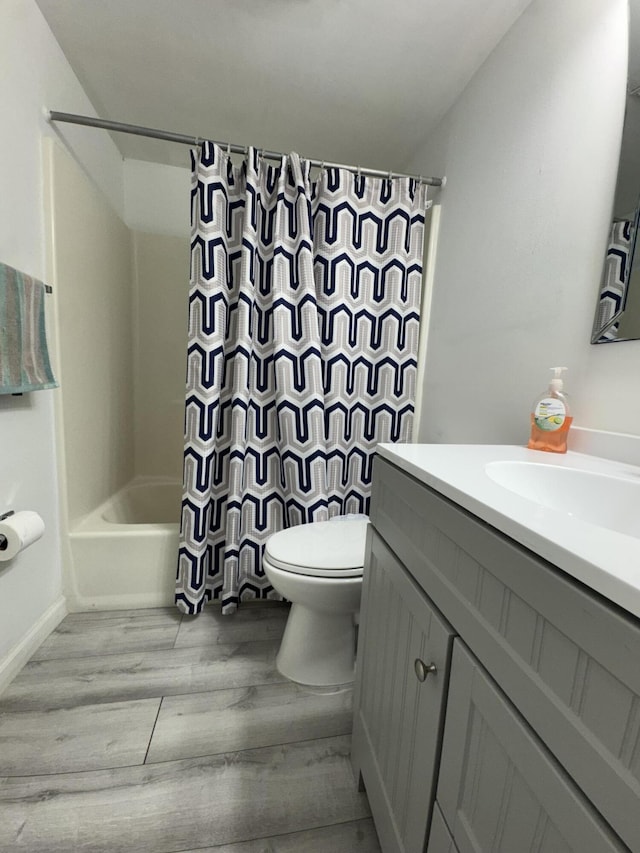 1518 Royal Forest Ct, Palm Springs, FL 33406 - full bathroom featuring vanity, wood finished floors, toilet, and shower / bath combo with shower curtain