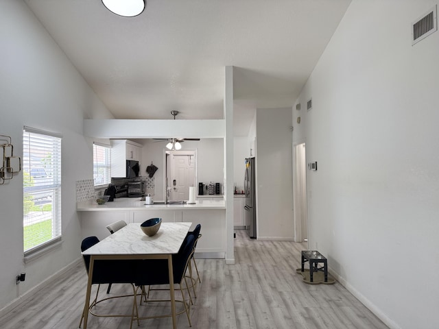 1518 Royal Forest Ct, Palm Springs, FL 33406 - dining space featuring light wood-style floors, a ceiling fan, and baseboards