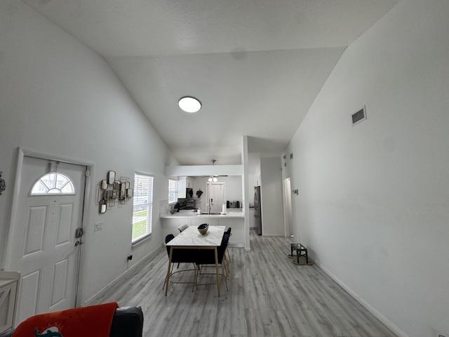 1518 Royal Forest Ct, Palm Springs, FL 33406 - foyer entrance with light wood-type flooring, high vaulted ceiling, and baseboards