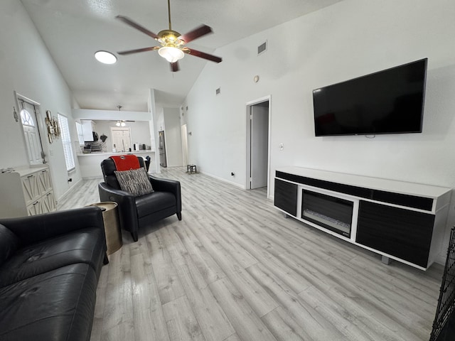1518 Royal Forest Ct, Palm Springs, FL 33406 - living room with a ceiling fan, light wood-style flooring, high vaulted ceiling, and baseboards