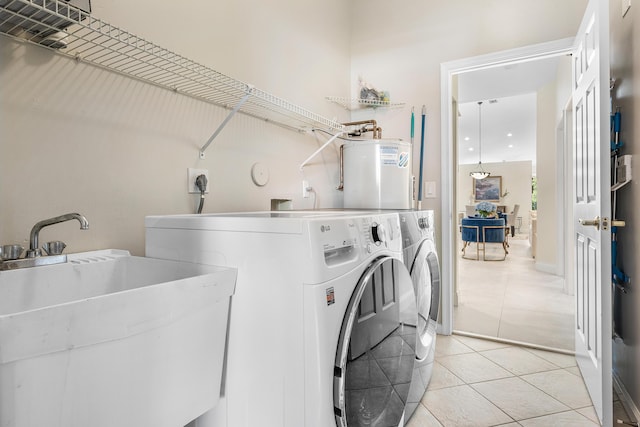 23193 Via Stel, Boca Raton, FL 33433 - washroom with water heater, washing machine and dryer, and light tile patterned flooring
