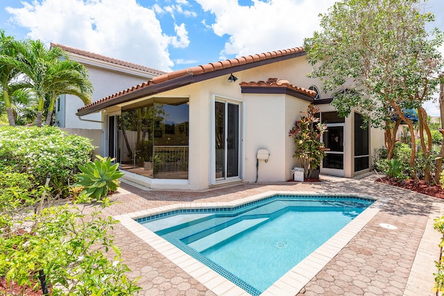 23193 Via Stel, Boca Raton, FL 33433 - back of house with an outdoor pool, stucco siding, a patio, and a sunroom