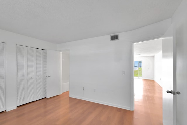 2936 Lake Shore Dr Unit 108, Riviera Beach, FL 33404 - unfurnished bedroom with wood finished floors and baseboards