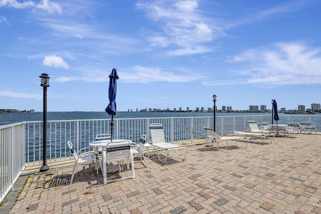 2936 Lake Shore Dr Unit 108, Riviera Beach, FL 33404 - view of patio / terrace with a water view and a view of skyline