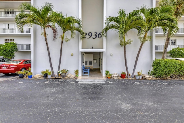 2936 Lake Shore Dr Unit 108, Riviera Beach, FL 33404 - view of exterior entry with stucco siding