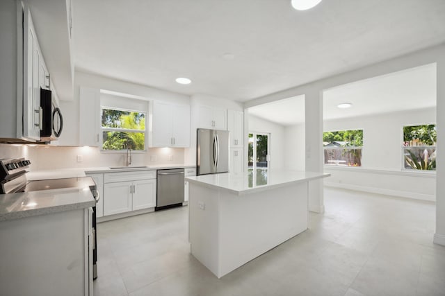 811 Hunter St, West Palm Beach, FL 33405 - kitchen featuring stainless steel appliances, a sink, plenty of natural light, white cabinets, and recessed lighting