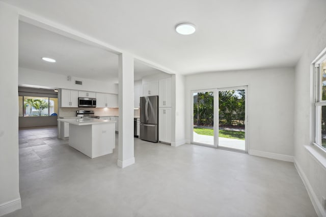811 Hunter St, West Palm Beach, FL 33405 - kitchen with stainless steel appliances, plenty of natural light, white cabinets, and light countertops