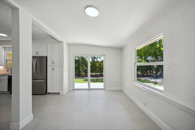 811 Hunter St, West Palm Beach, FL 33405 - unfurnished living room featuring a sink, baseboards, and lofted ceiling