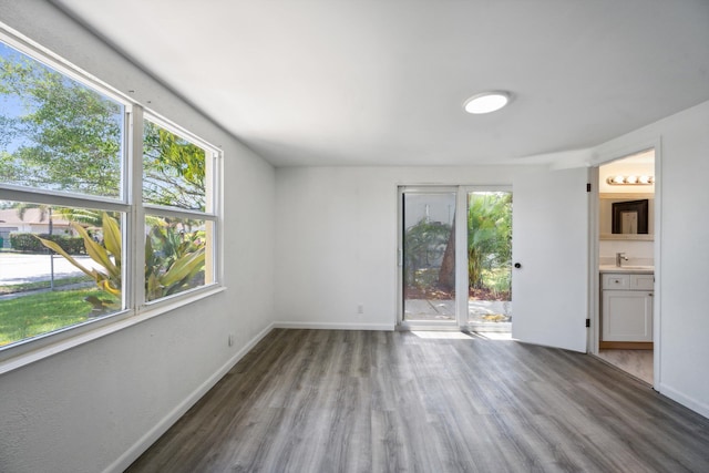 811 Hunter St, West Palm Beach, FL 33405 - empty room with wood finished floors, a sink, and baseboards