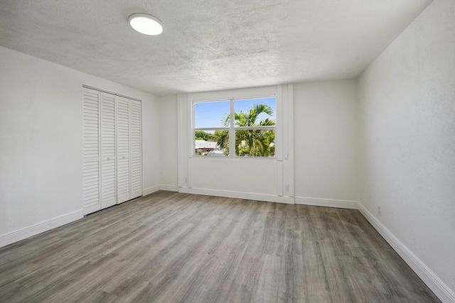 811 Hunter St, West Palm Beach, FL 33405 - unfurnished room with wood finished floors, baseboards, and a textured ceiling