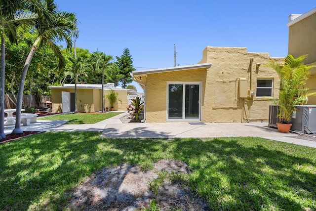 811 Hunter St, West Palm Beach, FL 33405 - rear view of property with a patio, cooling unit, and stucco siding
