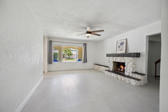 811 Hunter St, West Palm Beach, FL 33405 - unfurnished living room with ceiling fan, a fireplace, a textured ceiling, and baseboards