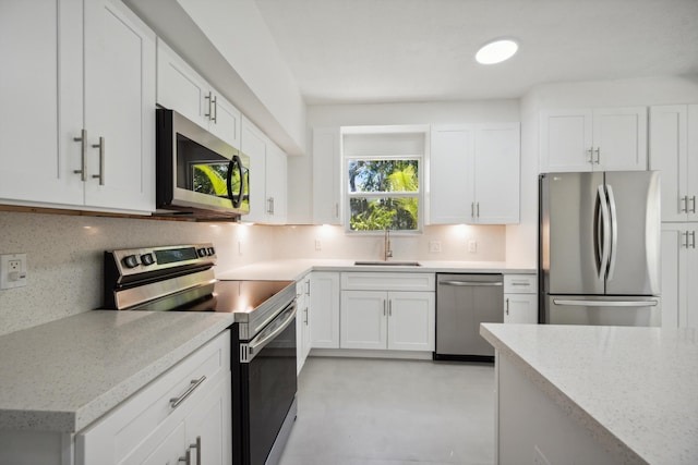 811 Hunter St, West Palm Beach, FL 33405 - kitchen with stainless steel appliances, a sink, decorative backsplash, and white cabinets