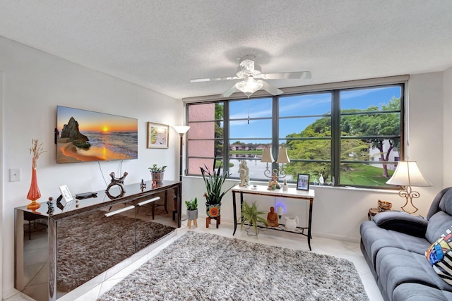 15075 Witney Rd Unit 212, Delray Beach, FL 33484 - living area featuring ceiling fan, tile patterned flooring, and a textured ceiling