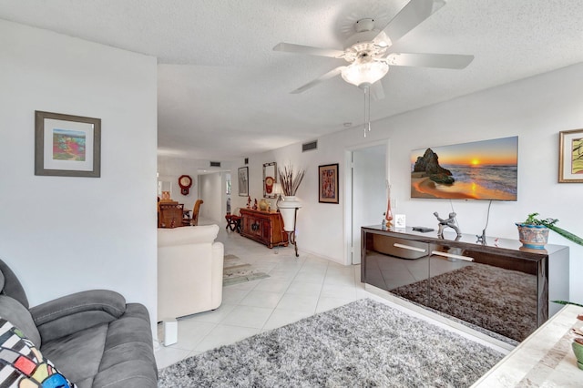 15075 Witney Rd Unit 212, Delray Beach, FL 33484 - living room featuring a ceiling fan, tile patterned floors, and a textured ceiling