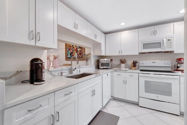 15075 Witney Rd Unit 212, Delray Beach, FL 33484 - kitchen with white appliances, a sink, white cabinets, light tile patterned flooring, and light stone counters