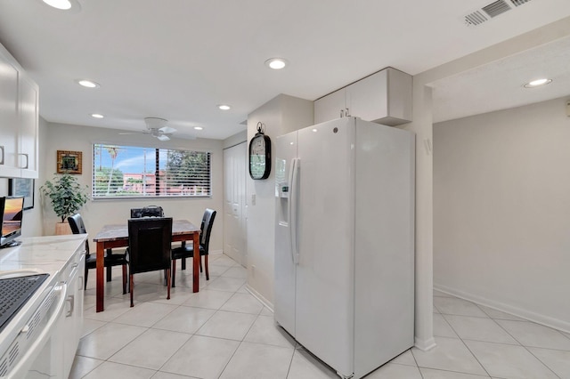 15075 Witney Rd Unit 212, Delray Beach, FL 33484 - kitchen featuring white fridge with ice dispenser, white cabinetry, ceiling fan, light tile patterned flooring, and recessed lighting