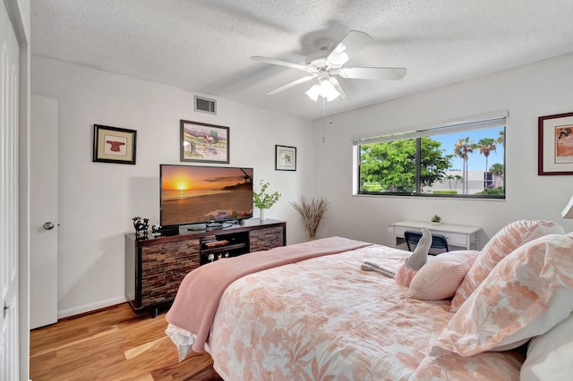 15075 Witney Rd Unit 212, Delray Beach, FL 33484 - bedroom with wood finished floors, a textured ceiling, a ceiling fan, and baseboards