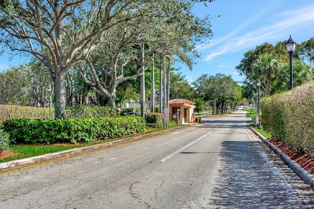 15075 Witney Rd Unit 212, Delray Beach, FL 33484 - view of asphalt street with street lights, curbs, and a gated entry